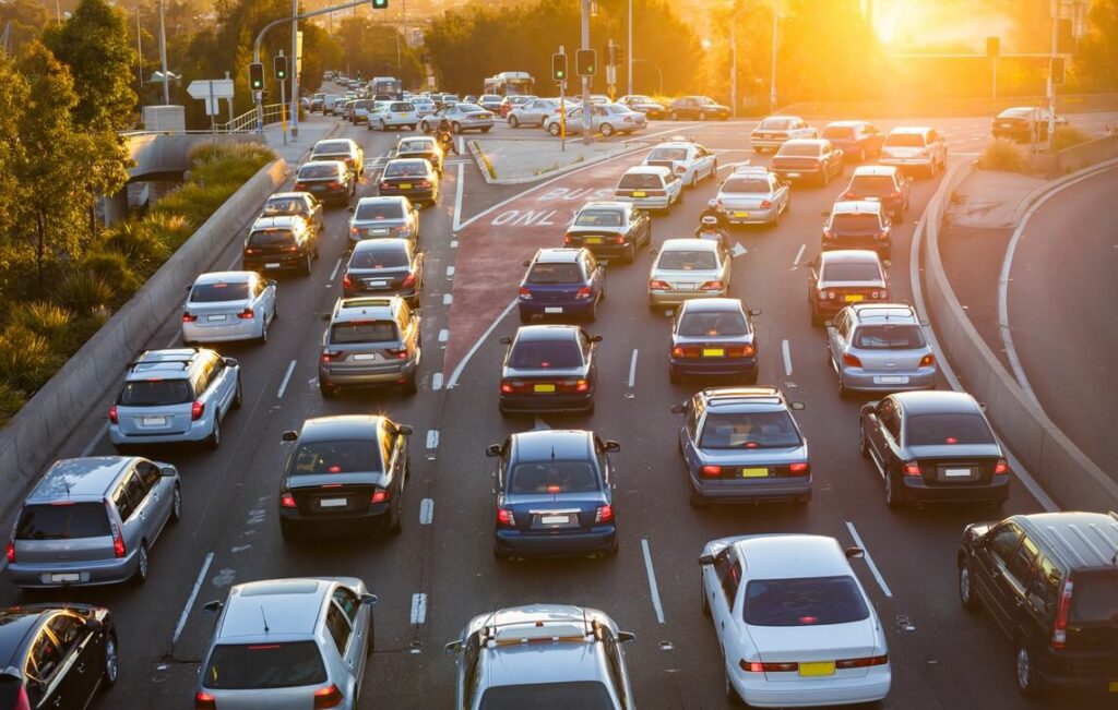 Rush hour on a 5-lane road in bumper-to-bumper traffic.