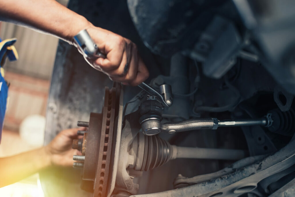 A person working on the brakes of a car.