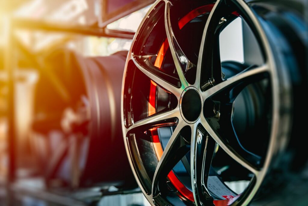 A high-performance alloy tire wheel is on display.