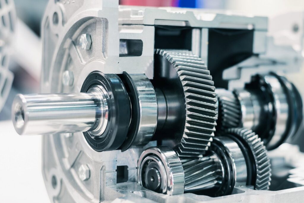 A cutaway model of a manual gearbox showing the gears.
