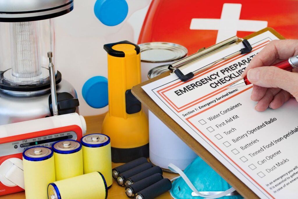 Emergency preparedness checklist with flashlight, batteries, radio, and first-aid supplies.