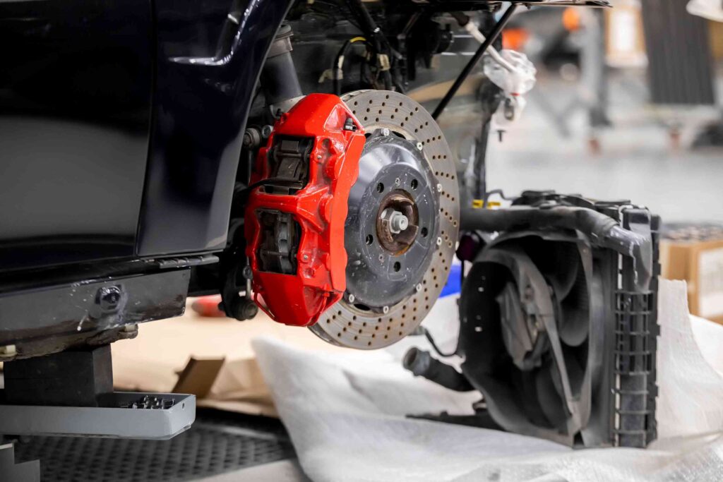 A brake rotor on a vehicle lifted in a service bay.